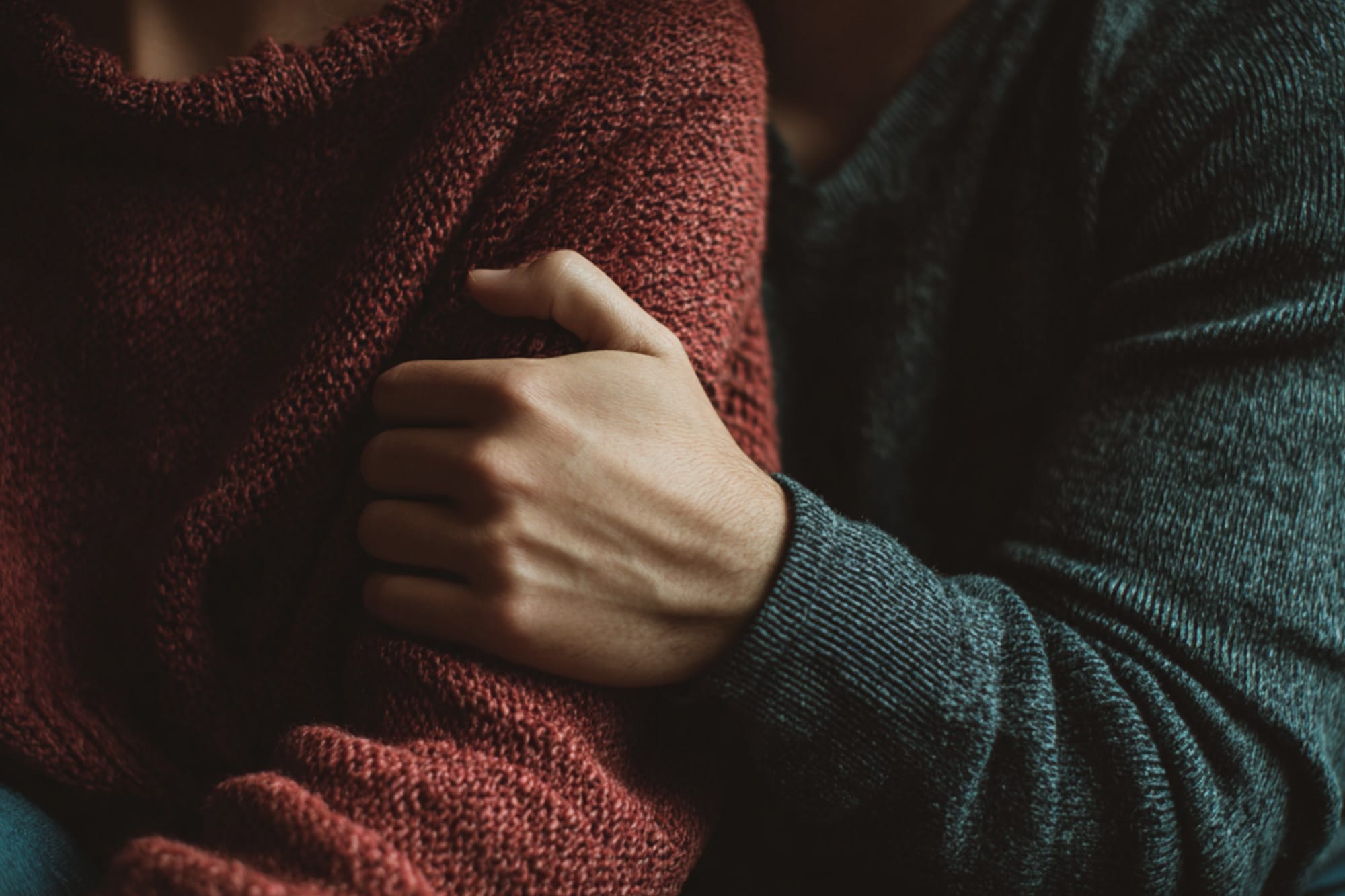 hands on shoulder in supportive gesture, soft natural light, emotional warmth