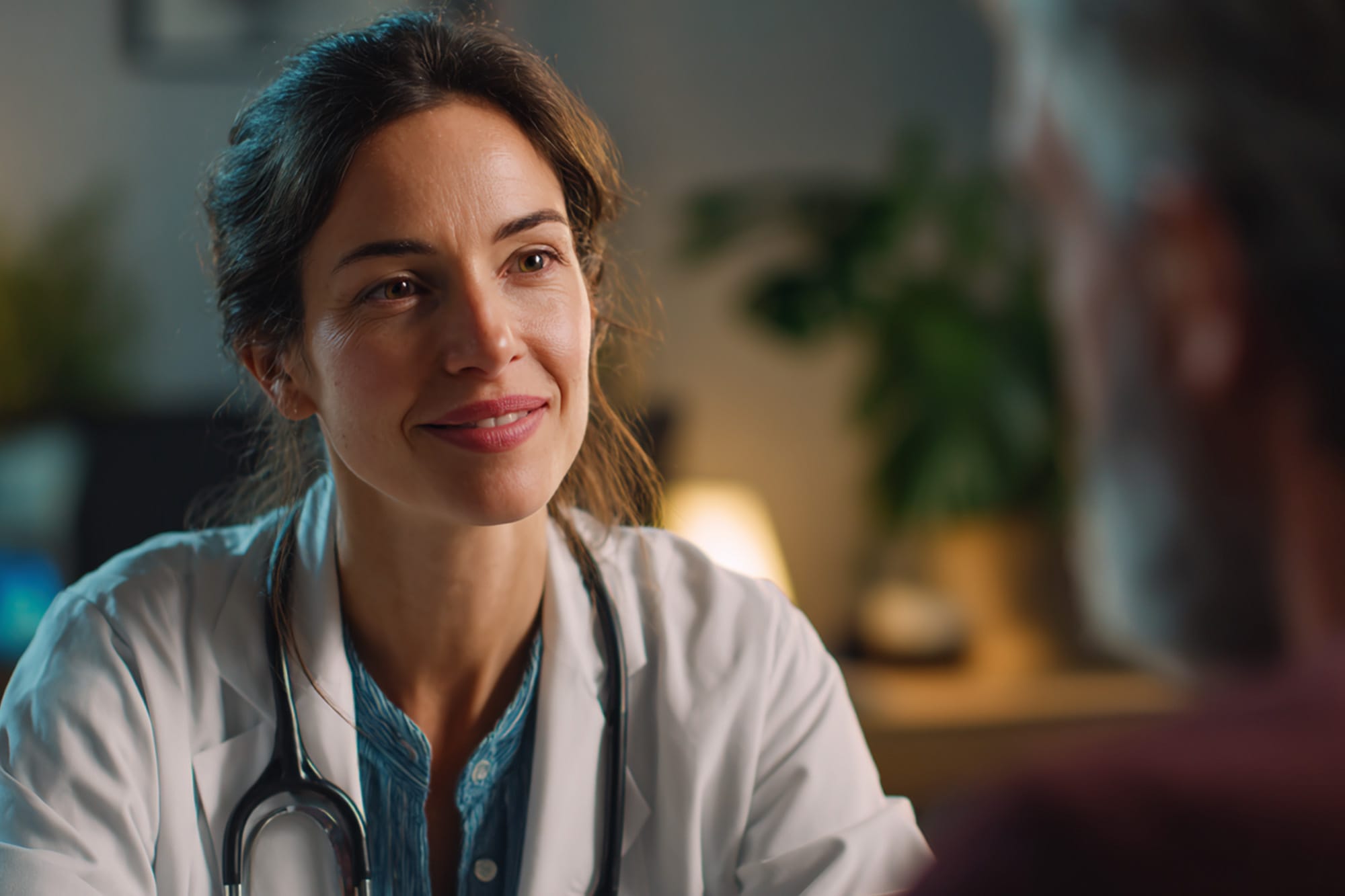 Medical professional speaking calmly with a patient in a clinical but warm setting, trust-focused imagery
